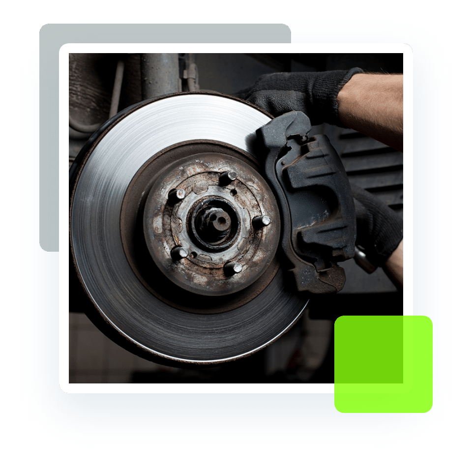 Image of an auto mechanic's hand working on a brake with exposed rotor and pad. Concept image of brake services and repair at Quality Car Care in North Liberty, IA.