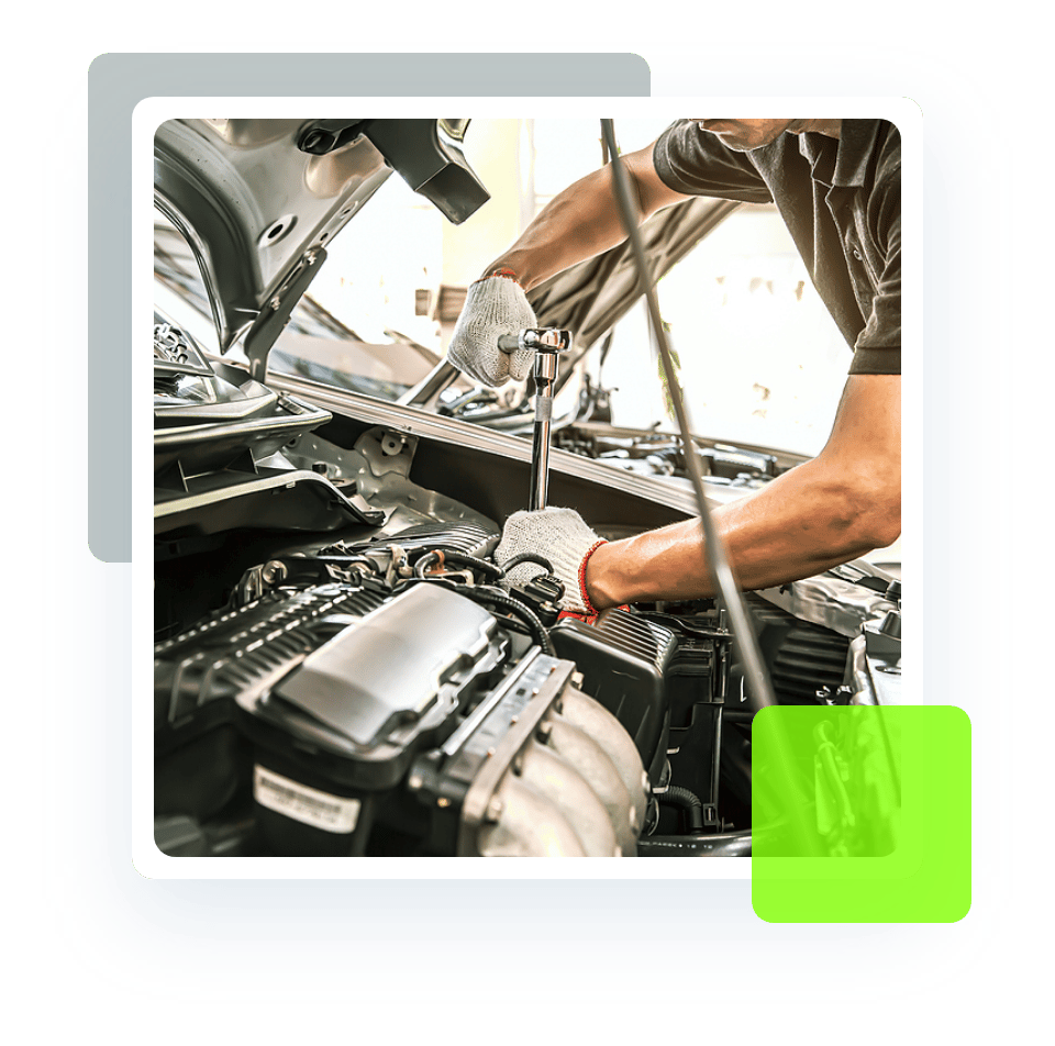 Image of an auto technician holding a wrench and fixing a car under the hood. Concept image of auto repair and maintenance at Quality Car Care in North Liberty, IA.