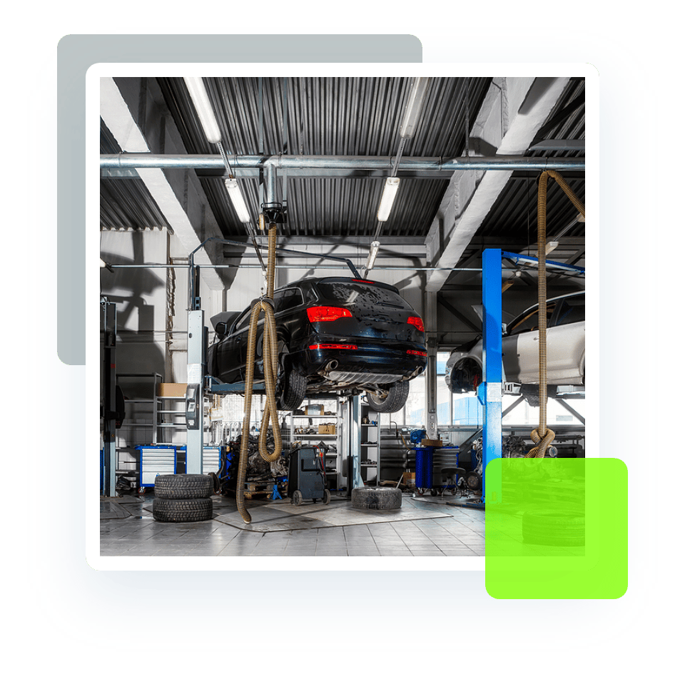 Image of a car under repair and maintenance on a lift. Inside look at an auto repair shop. Concept image of auto repair and maintenance at Quality Car Care in North Liberty, IA.