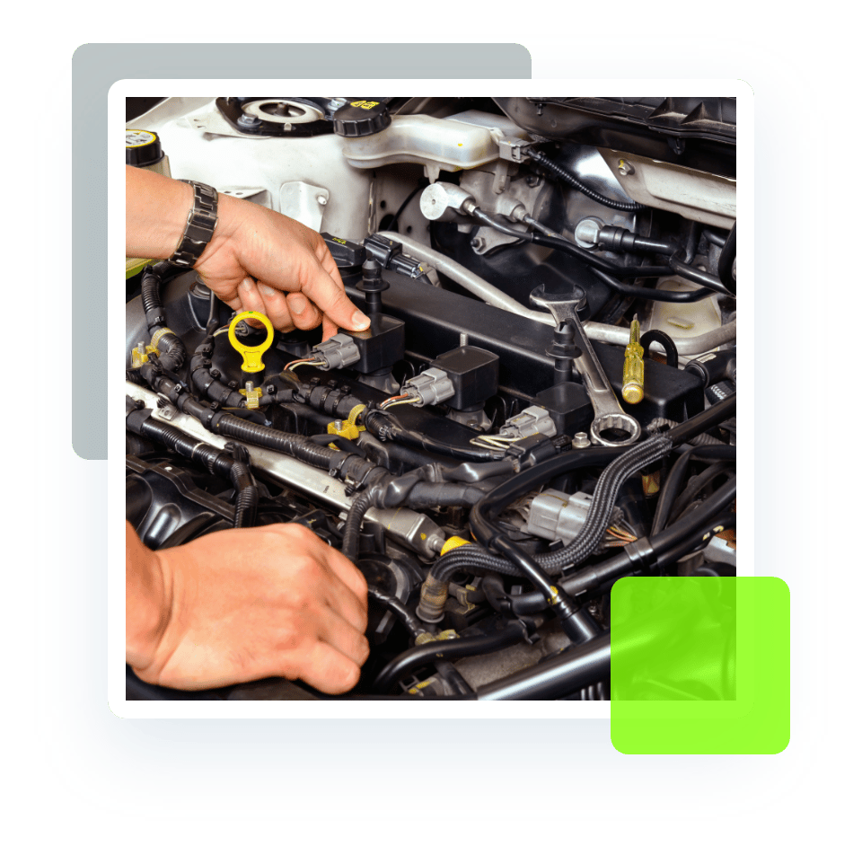 Closeup image of an auto mechanic checking a car engine and other components. Concept image of engine repair and services at Quality Car Care in North Liberty, IA.