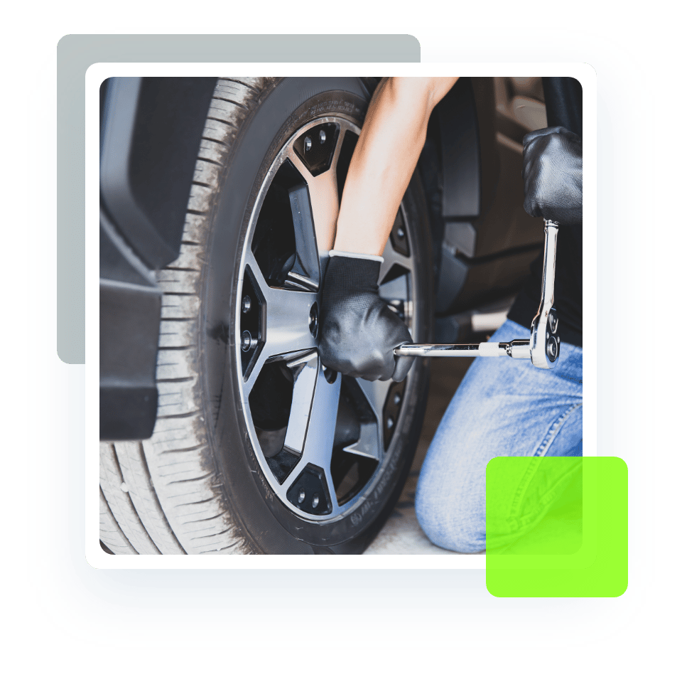 Image of an auto technician trying to loosen a lug nut of car tire. Concept image of new tires and other tire services at Quality Car Care in North Liberty, IA.