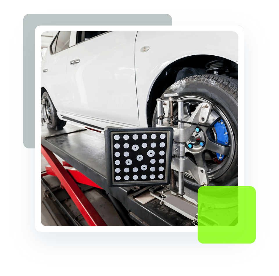 Image of an alignment sensor attached to a front wheel. Concept image of wheel alignment at Quality Car Care in North Liberty, IA.