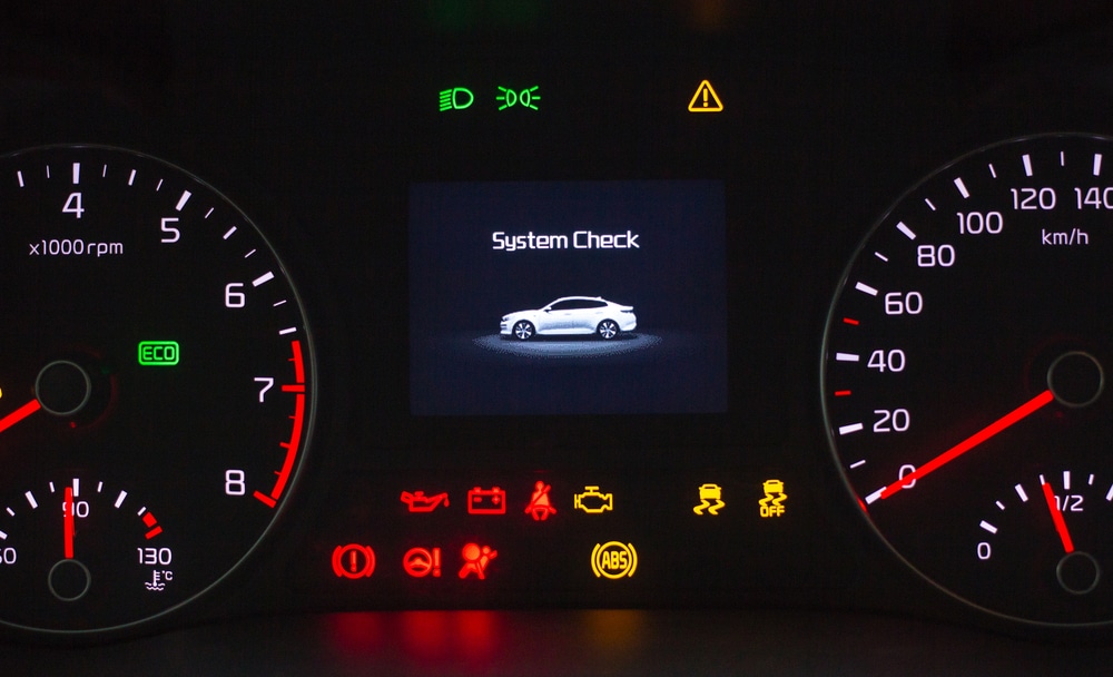a closeup picture of a dashboard showing check engine light and diagnostic tool | Quality Care