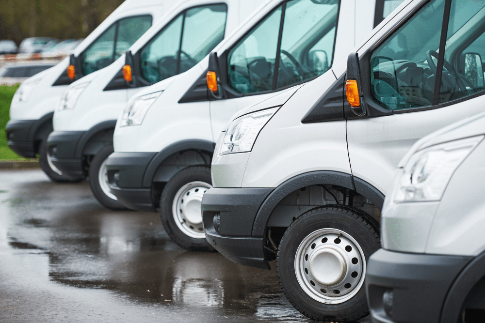 sprinter services, auto repair in North Liberty, IA by Quality Car Care. Sprinter and Freightliner van repair in North Liberty, IA by Quality Car Care. Image of a fleet of white service vans parked on wet pavement.