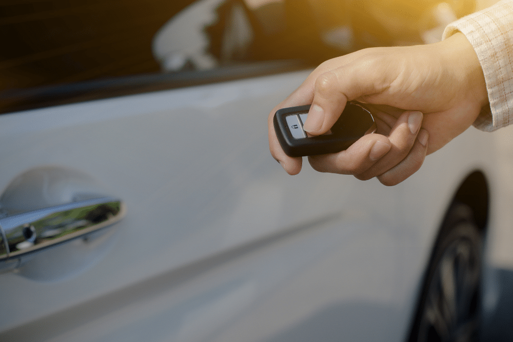 Key fob service in North Liberty, IA at Quality Car Care. Close-up of a remote lock press, highlighting programming and remote start diagnostics.